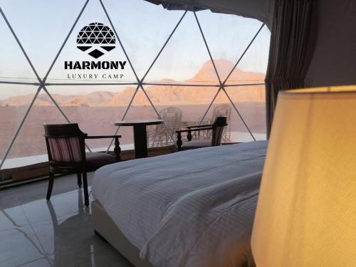 Harmony Luxury Camp في وادي رم: غرفة نوم بسرير ومنظر صحراوي