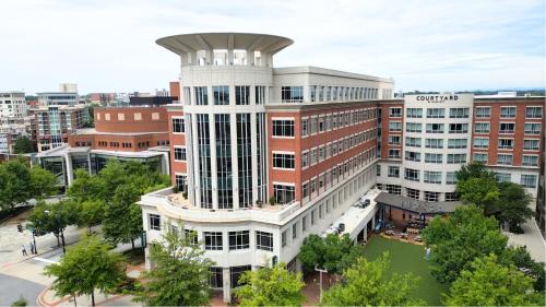 an architectural rendering of a building in a city at Courtyard by Marriott Greenville Downtown in Greenville