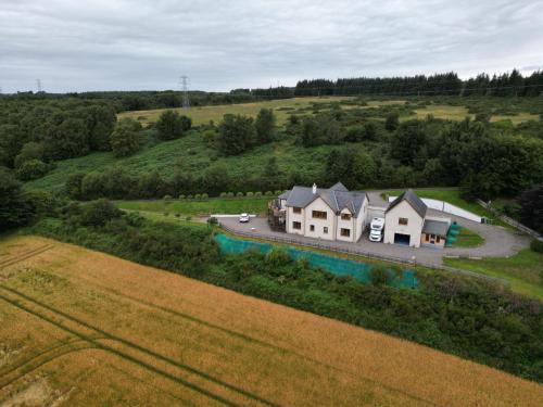 an aerial view of a house in a field at Doura Lodge in Inverness