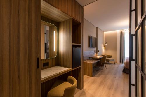 a corridor of a hotel room with a mirror at Hotel Giralda Center in Seville