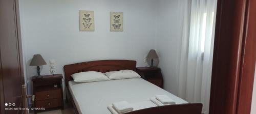 a bedroom with a bed with two white pillows at Nisos family apartments in Yénion