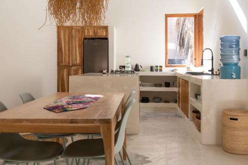 a kitchen with a wooden table and a dining room at Villa Luna - Gili Air in Gili Air