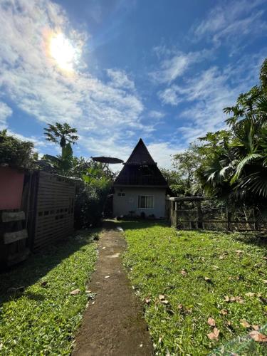 a house with a grass yard with a pathway leading to it at Darwin's temple in San Cristobal