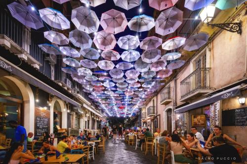 a hallway with umbrellas hanging from the ceiling at La Casa di Nino in Catania