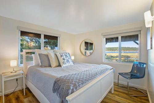 - une chambre avec un lit et 2 fenêtres dans l'établissement Marrowstone Island Beach Cabin, à Nordland