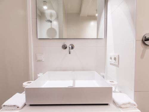 a white bath tub sitting next to a white sink at Herengracht B&nB in Amsterdam