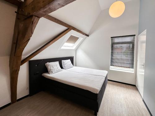 ein Schlafzimmer mit einem großen Bett im Dachgeschoss in der Unterkunft B&B aan de Markt in Roermond