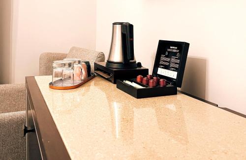 a counter with a coffee maker and a blender on it at Excelsior INN in Turda