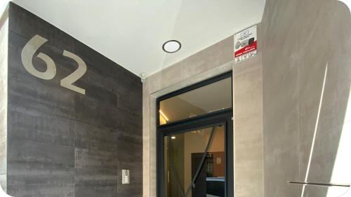 a clock on the wall of a building with a door at AVA Flats in Alicante