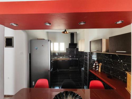 a kitchen with a table and red ceiling at ~Lovey-Dovey~ nice & central apartment ~Sitia~ in Sitia