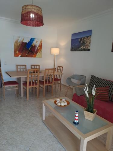 a living room with a couch and a table at T2 Vila Atlântida Praia Vilamoura in Quarteira