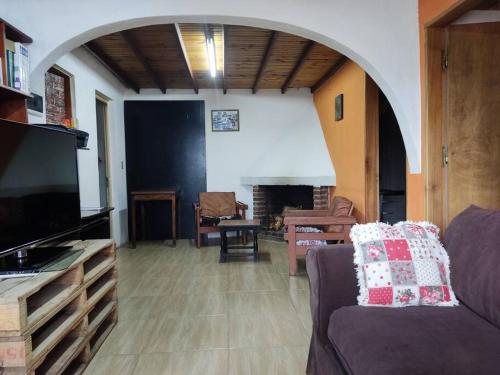 a living room with a couch and a fireplace at Casa, para máximo 6 personas in Melo