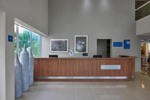 a lobby with a reception desk in a building at City Express by Marriott Tuxtla Gutiérrez in Tuxtla Gutiérrez