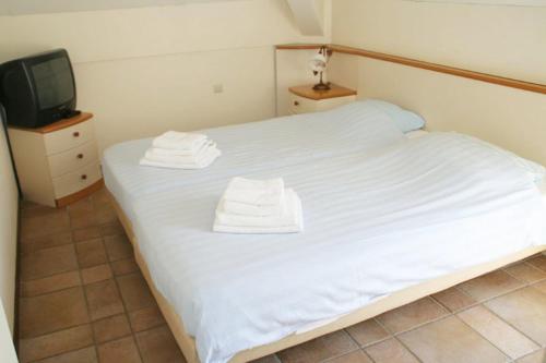 Posteľ alebo postele v izbe v ubytovaní Appartementen De Buteriggel
