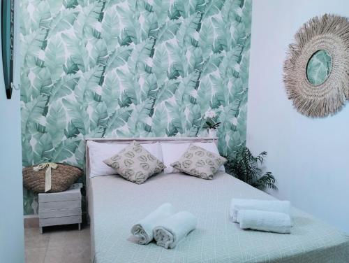 a bedroom with a bed with pillows and a wall at La casita in Arona