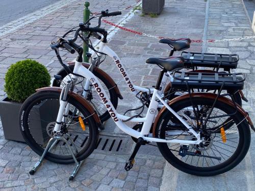 due biciclette parcheggiate l'una accanto all'altra in una strada di Room4You a Oulx
