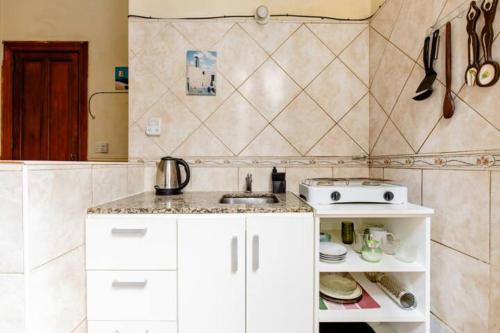 a kitchen with a sink and a stove in it at Dante y compañía in Buenos Aires