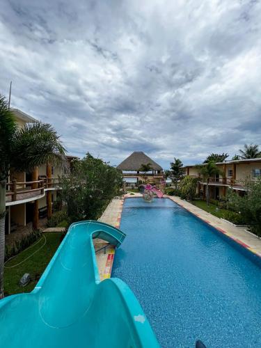 a swimming pool with a slide in a resort at Hotel Pazifico en Monterrico in Monterrico