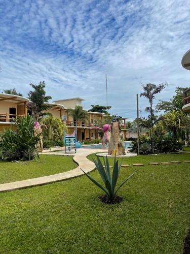 a park with a plant in the grass at Hotel Pazifico en Monterrico in Monterrico