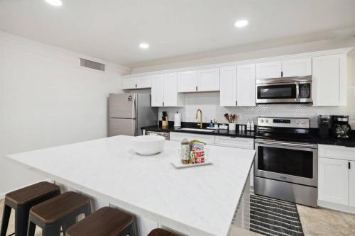 a kitchen with white cabinets and a white counter top at Home 8 Minutes to Old Town Scottsdale in Scottsdale