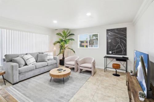 a living room with a couch and a table at Home 8 Minutes to Old Town Scottsdale in Scottsdale