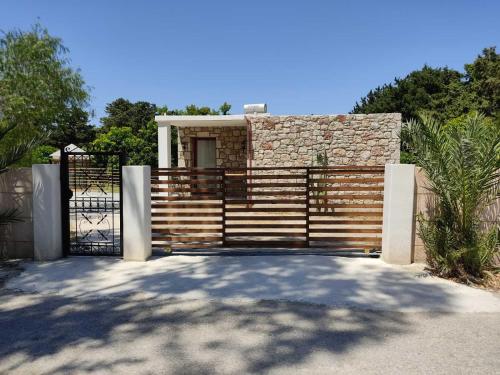 a gate to a house with a fence at Tropical Garden Prime Accommodation in Faliraki