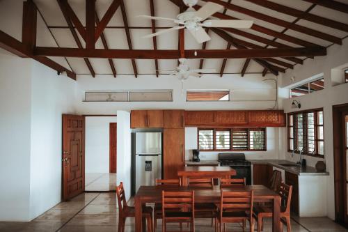 a dining room with a table and chairs and a ceiling at Salvatierra Beachfront Hotel in Puerto Coyote