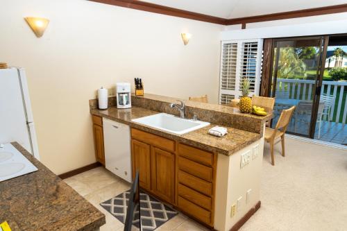 a kitchen with a sink and a counter top at Luxury condo in Poipu in Koloa