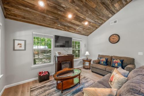 a living room with a couch and a table at The Otter Box Cabin - 92 Acres Beside DeSoto State Park in Fort Payne