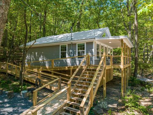a tiny house in the woods with a deck at The Otter Box Cabin - 92 Acres Beside DeSoto State Park in Fort Payne