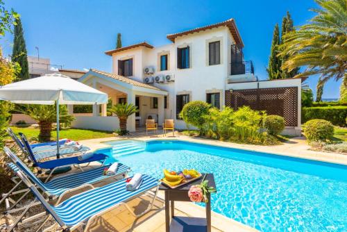 a villa with a swimming pool and a house at Villa Iliana in Polis Chrysochous