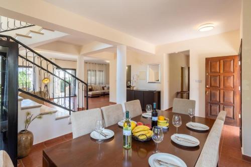 a dining room with a table and chairs at Villa Iliana in Polis Chrysochous