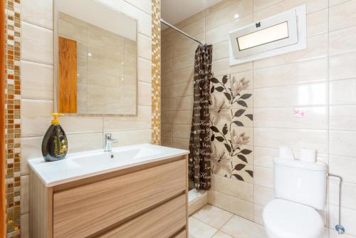 a bathroom with a sink and a toilet at Villa Paradiso Sunset in Pomos