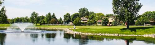 a fountain in the middle of a pond in a park at Delta Hotels by Marriott Fargo in Fargo