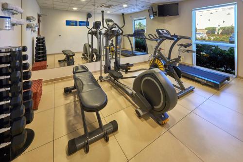 a gym with several treadmills and exercise bikes at City Express by Marriott Manzanillo in Manzanillo