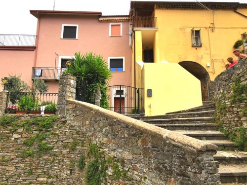 a group of buildings and a stone wall with stairs at Nennella Cilento House in Cuccaro Vetere