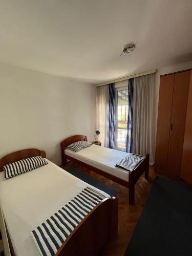 a room with two beds and a window at Apartment Centropolis in Mostar