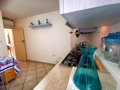 a blue vase sitting on top of a kitchen counter at Nennella Cilento House in Cuccaro Vetere