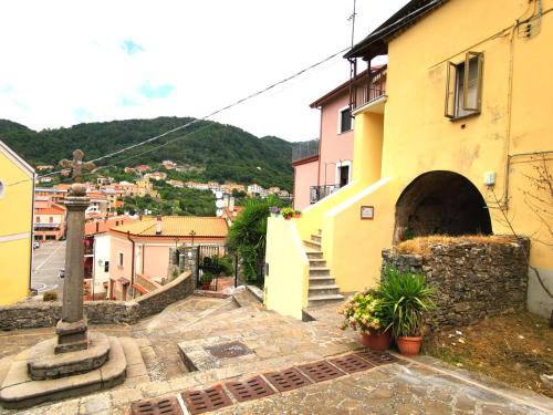 a building with a cross next to a street at Nennella Cilento House in Cuccaro Vetere