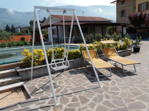 two chairs and a swing on a patio at Bed & Breakfast Ciancaleoni in Rivotorto 
