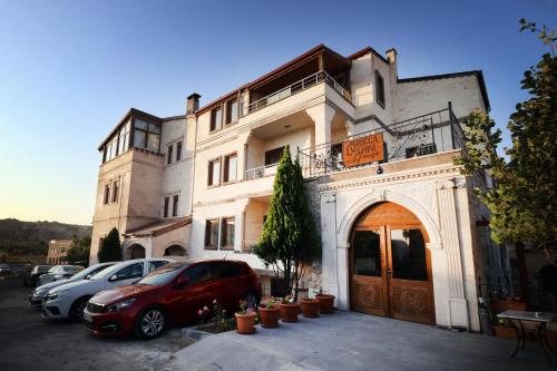 a red car parked in front of a building at Rocca Stone House in Goreme