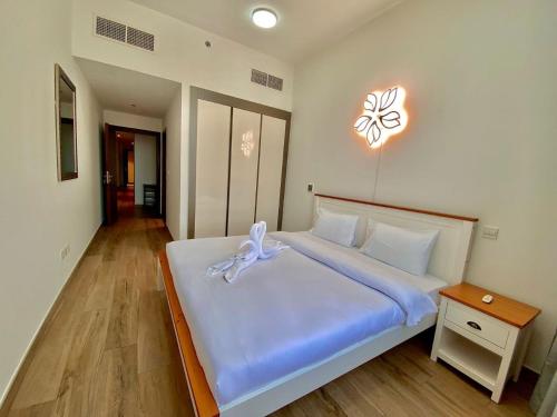a bedroom with a large bed with a bow on it at New Modern Style 1 Bedroom in Dubai