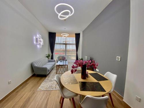 a dining room with a table and chairs at New Modern Style 1 Bedroom in Dubai