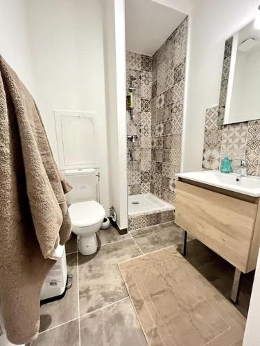 une salle de bain avec toilettes et lavabo dans l'établissement L'Aventurine - Romans, à Romans-sur-Isère