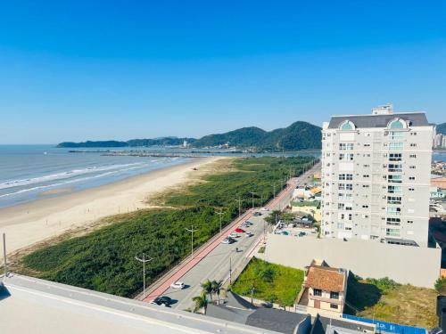 a view of the beach from the balcony of a building at Apto Studio Square 990 - Vista Mar in Navegantes