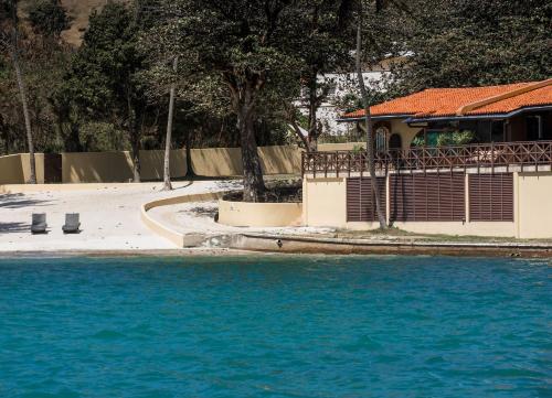 a pool of blue water in front of a building at Secret Harbour Boutique Hotel and Marina in Lance aux Épines