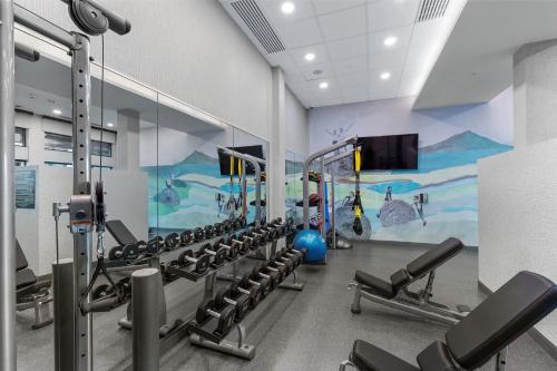 a fitness room with a gym with a mural at Residence Inn by Marriott Atlanta Covington in Covington