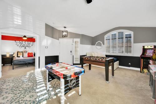 a living room with a table and a pool table at Sports Themed--Automated King Bed--Family Friendly--5 miles to Strip in Henderson