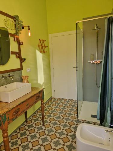 a bathroom with a sink and a shower at Don Ciccio Capashome in Ceglie Messapica