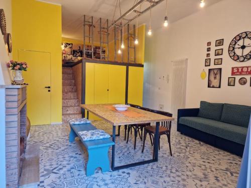 a living room with a table and a couch at Don Ciccio Capashome in Ceglie Messapica